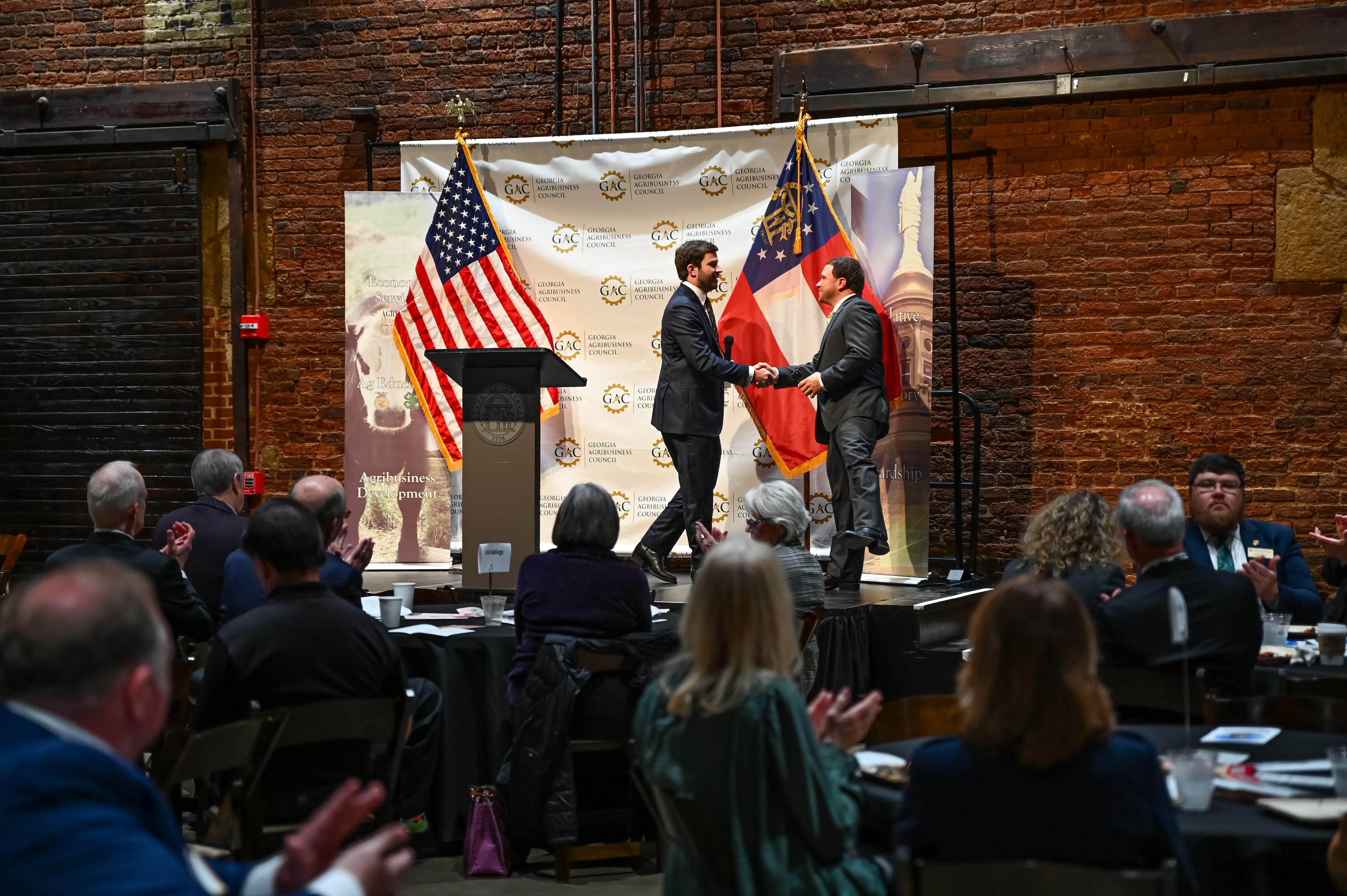Jake Tench, GAC, and Ag Commissioner, Tyler Harper, shake hands at Annual Legislative Brekafast